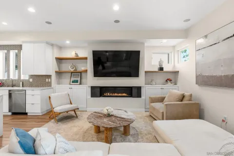 a living room with furniture a fireplace and a flat screen tv