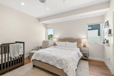 a bedroom with a large bed and a flat screen tv