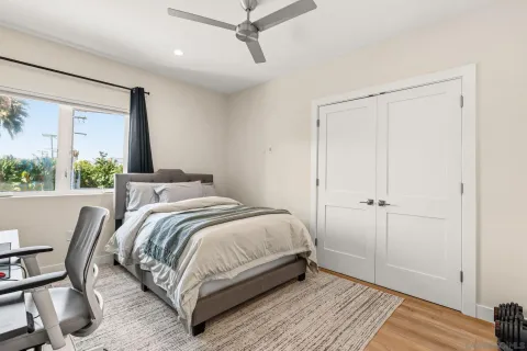 a bedroom with a bed and a desk