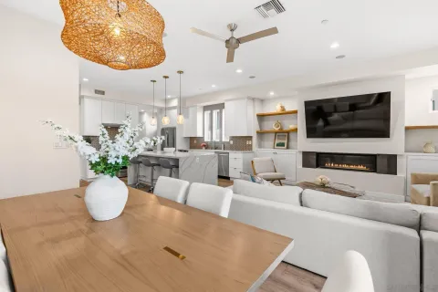 a living room with furniture a flat screen tv and a chandelier