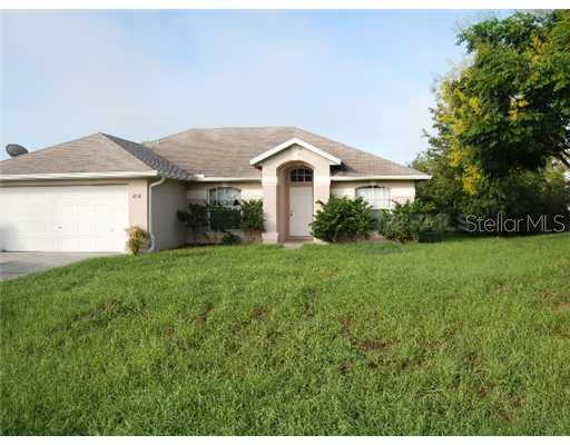 2368 Fitzpatrick Terrace Deltona, FL 32725 - Photo 1 of 1 a front view of a house with garden