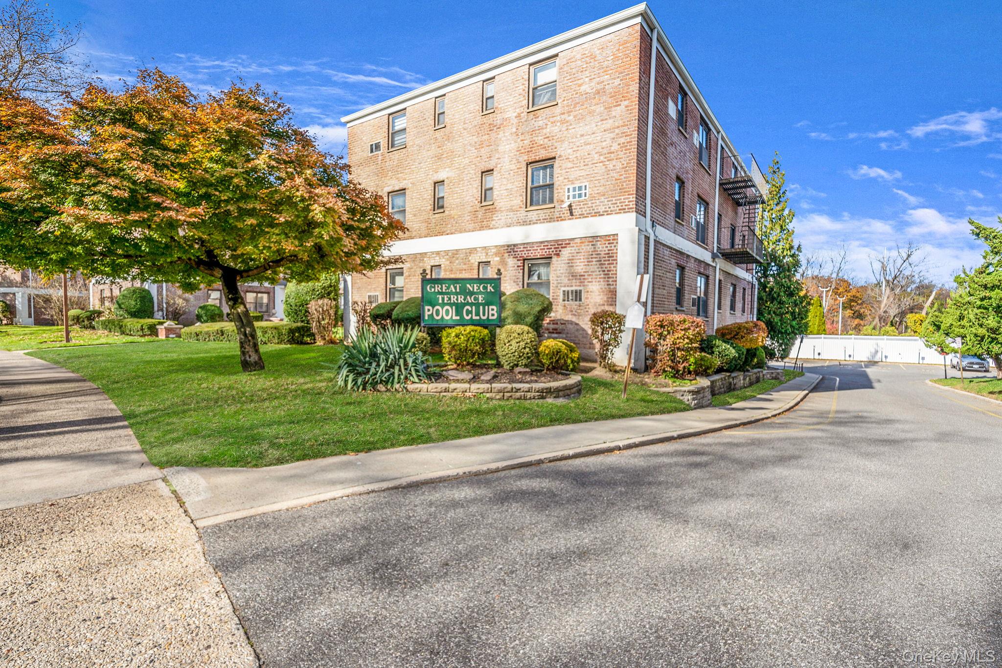 8 Terrace Circle, Unit 1G Great Neck, NY 11021 - Photo 11 of 17 a view of a building with a yard