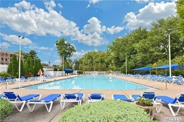 8 Terrace Circle, Unit 1G Great Neck, NY 11021 - Photo 12 of 17 a view of a swimming pool and lounge chairs