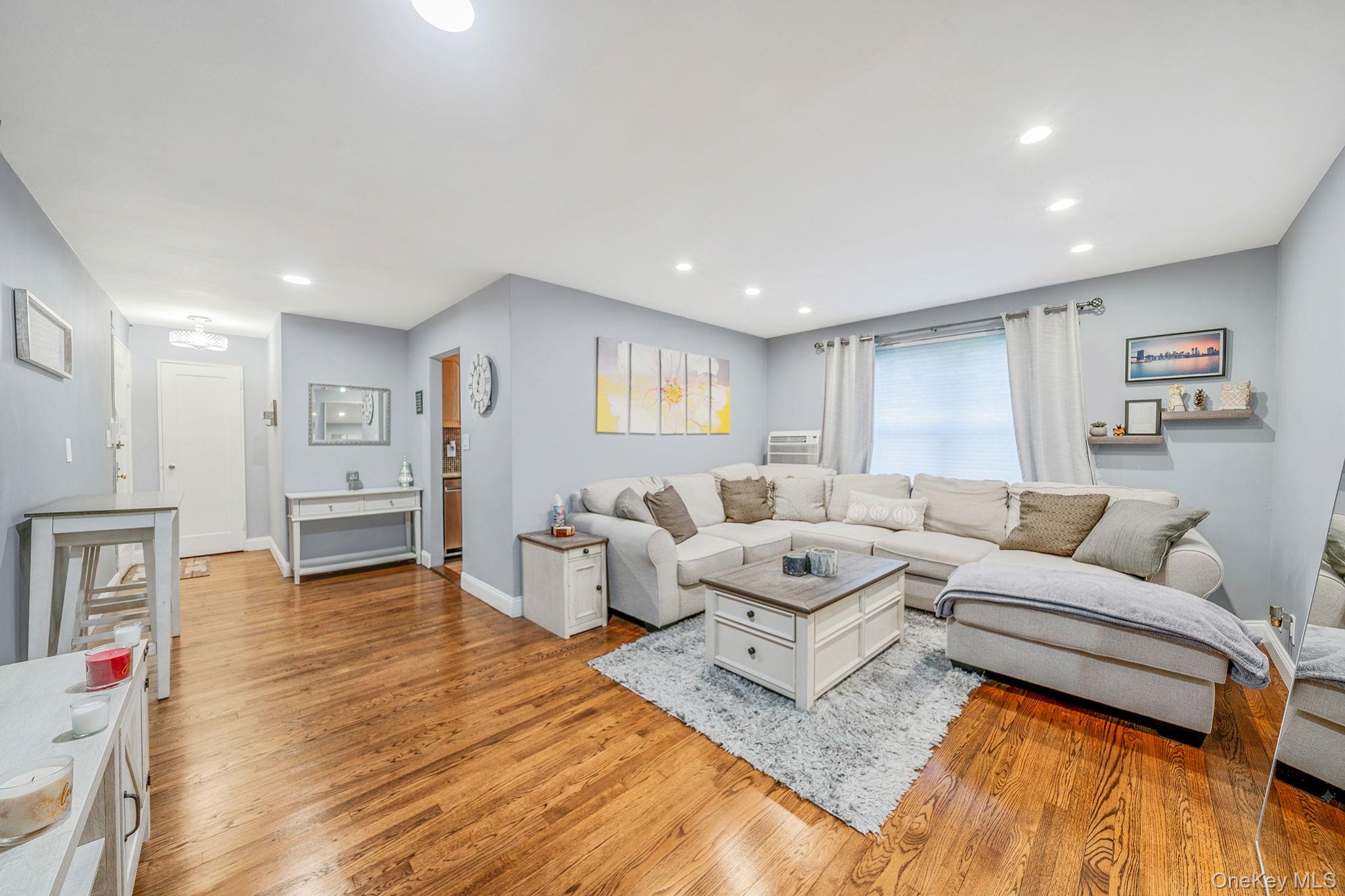 8 Terrace Circle, Unit 1G Great Neck, NY 11021 - Photo 7 of 17 a living room with furniture and a wooden floor
