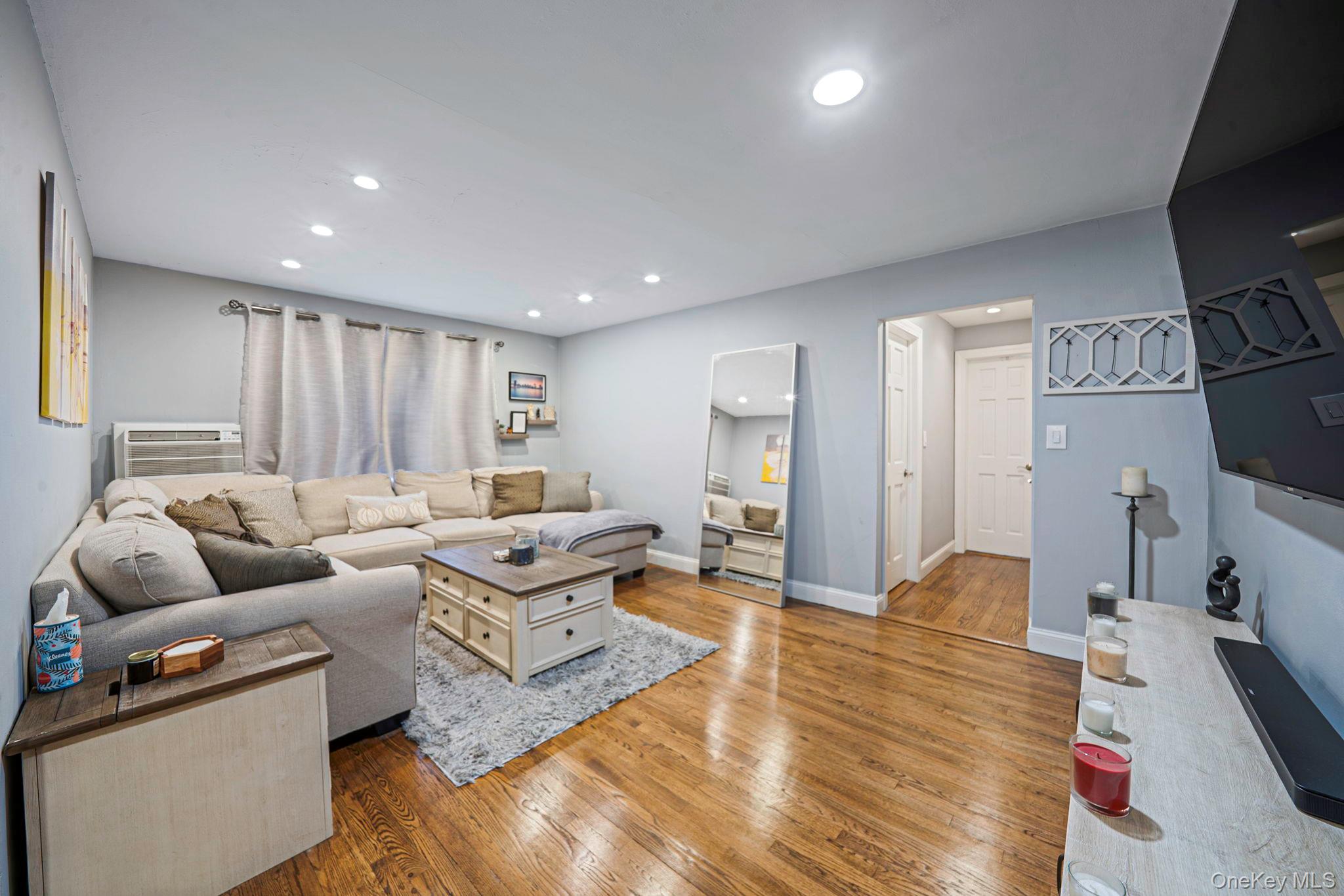 8 Terrace Circle, Unit 1G Great Neck, NY 11021 - Photo 8 of 17 a living room with furniture and a flat screen tv