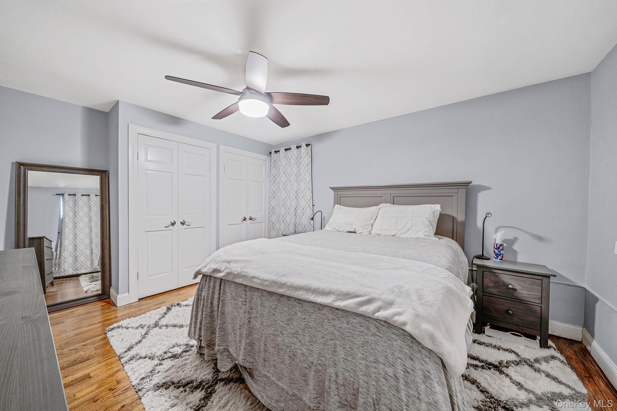 8 Terrace Circle, Unit 1G Great Neck, NY 11021 - Photo 9 of 17 a spacious bedroom with a bed and wooden floor