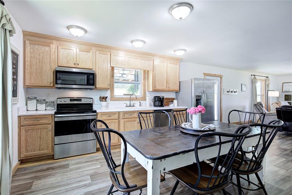 765 Addison Road Buchanan, GA 30113 - Photo 14 of 50 a kitchen with a dining table chairs and stainless steel appliances