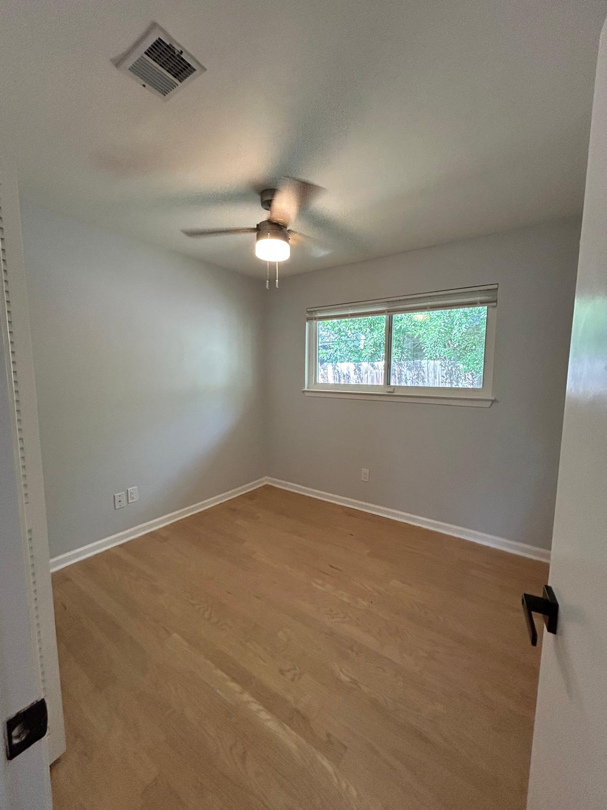 11803 Charing Cross Road Austin, TX 78759 - Photo 8 of 19 Empty room with a ceiling fan and light wood-style flooring