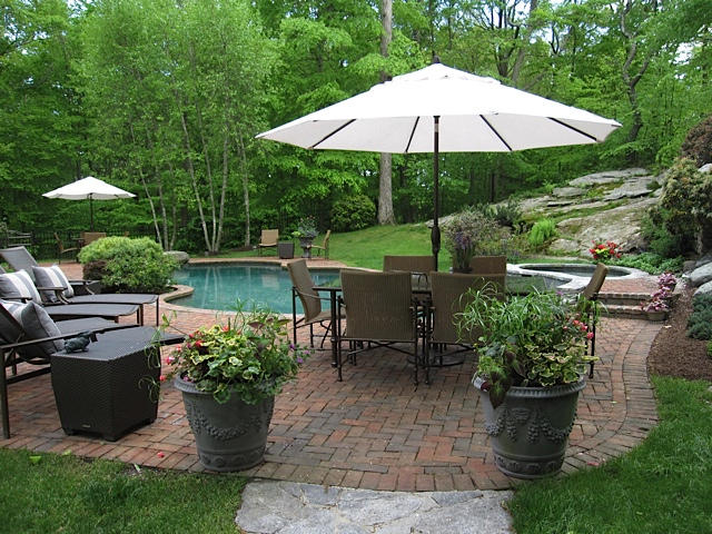 207 Jonathan Road New Canaan, CT 06840 - Photo 27 of 30 a view of a house with backyard sitting area and garden