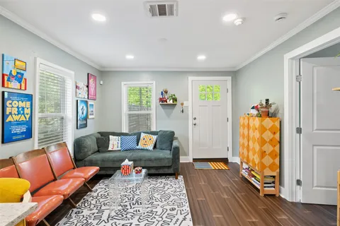 a living room with furniture and wooden floor