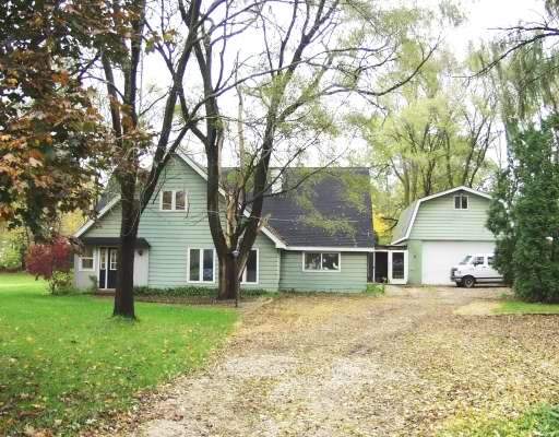 N749 Old Kirk Road West Chicago, IL 60185 - Photo 1 of 1 a house with trees in the background