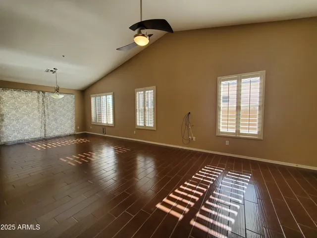 a view of wooden floor and windows in a room