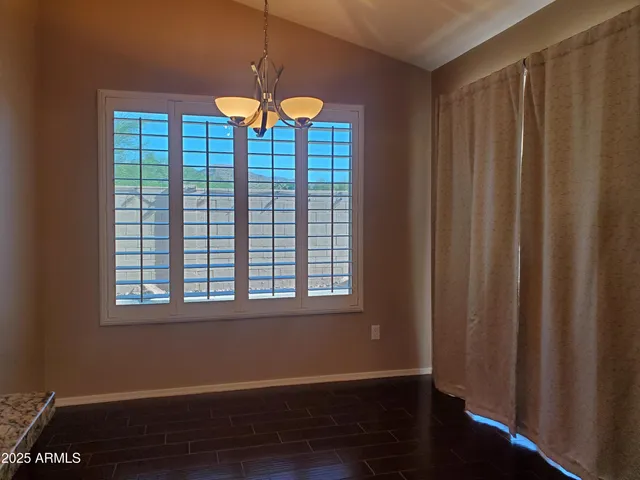 a view of an empty room with window and fireplace