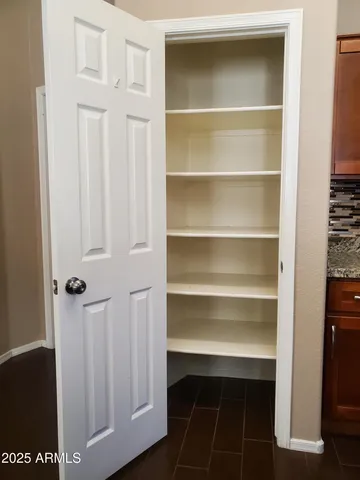 a bathroom with a granite countertop double vanity sink a mirror and a bathtub