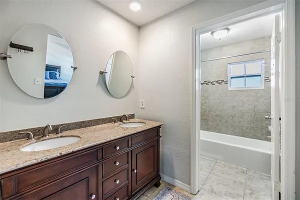 a bathroom with a double vanity sink and a mirror