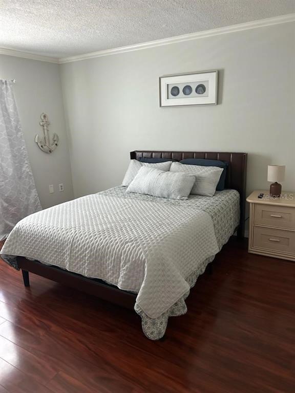 701 Poinsettia Road, Unit 306 Belleair, FL 33756 - Photo 15 of 25 a large bed sitting in a bedroom next to a small bathroom