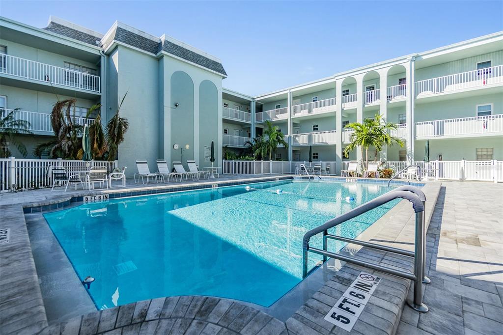 701 Poinsettia Road, Unit 306 Belleair, FL 33756 - Photo 17 of 25 a view of a swimming pool with a patio