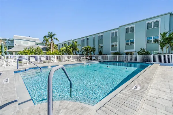 swimming pool with outdoor seating and plants
