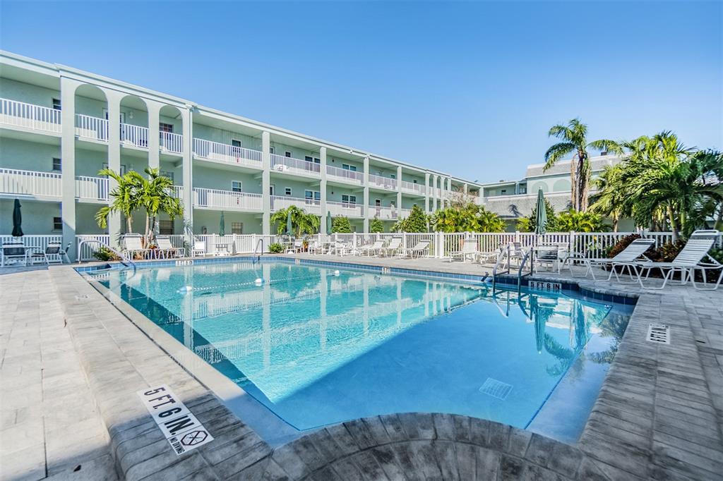 701 Poinsettia Road, Unit 306 Belleair, FL 33756 - Photo 19 of 25 a view of a swimming pool with outdoor seating