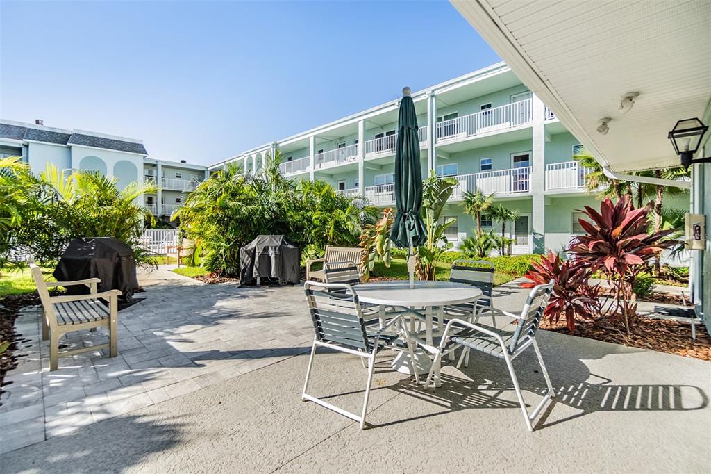701 Poinsettia Road, Unit 306 Belleair, FL 33756 - Photo 20 of 25 a view of a patio with plants and chairs