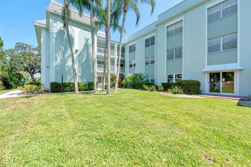 701 Poinsettia Road, Unit 306 Belleair, FL 33756 - Photo 21 of 25 a front view of a house with a yard