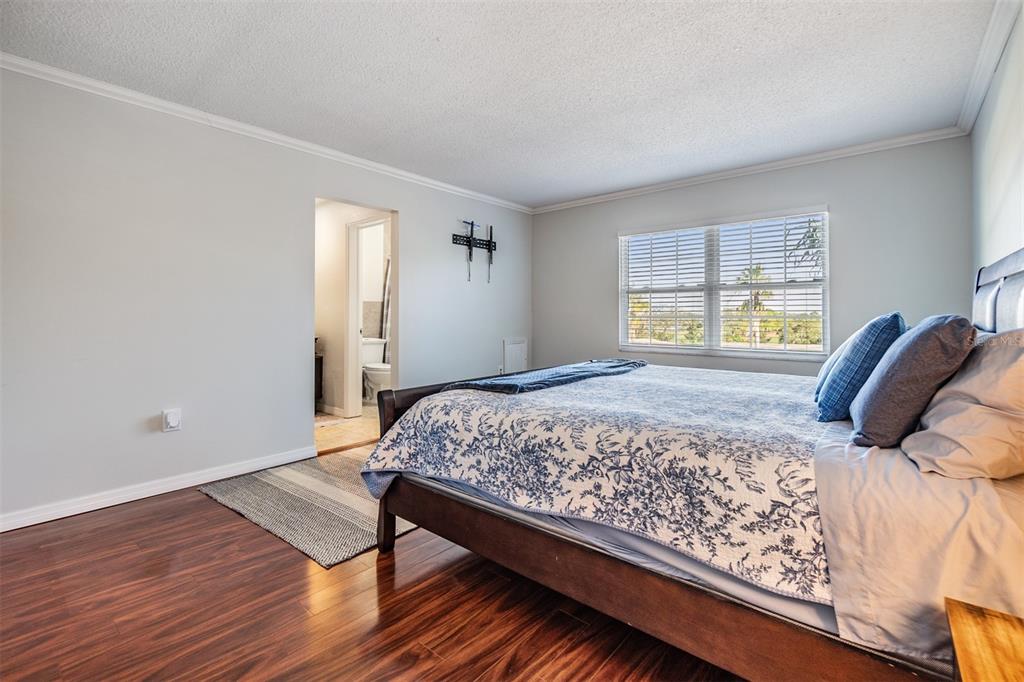 701 Poinsettia Road, Unit 306 Belleair, FL 33756 - Photo 9 of 25 a bedroom with a bed and window