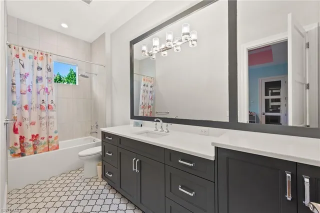 a very nice looking room with a large window and white cabinets