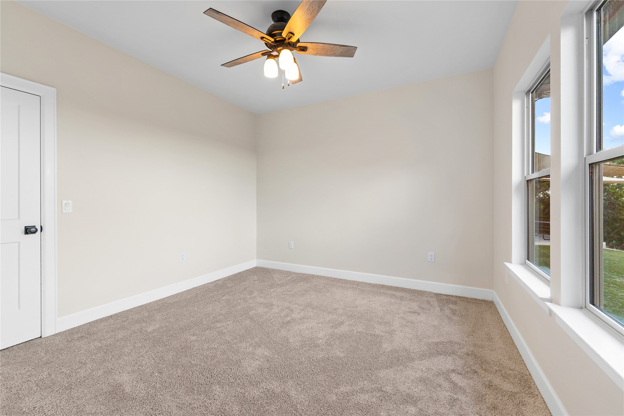 1017 Westland Ridge Road Dripping Springs, TX 78620 - Photo 21 of 40 Thick carpeting and dual windows enhance this versatile secondary bedroom space.