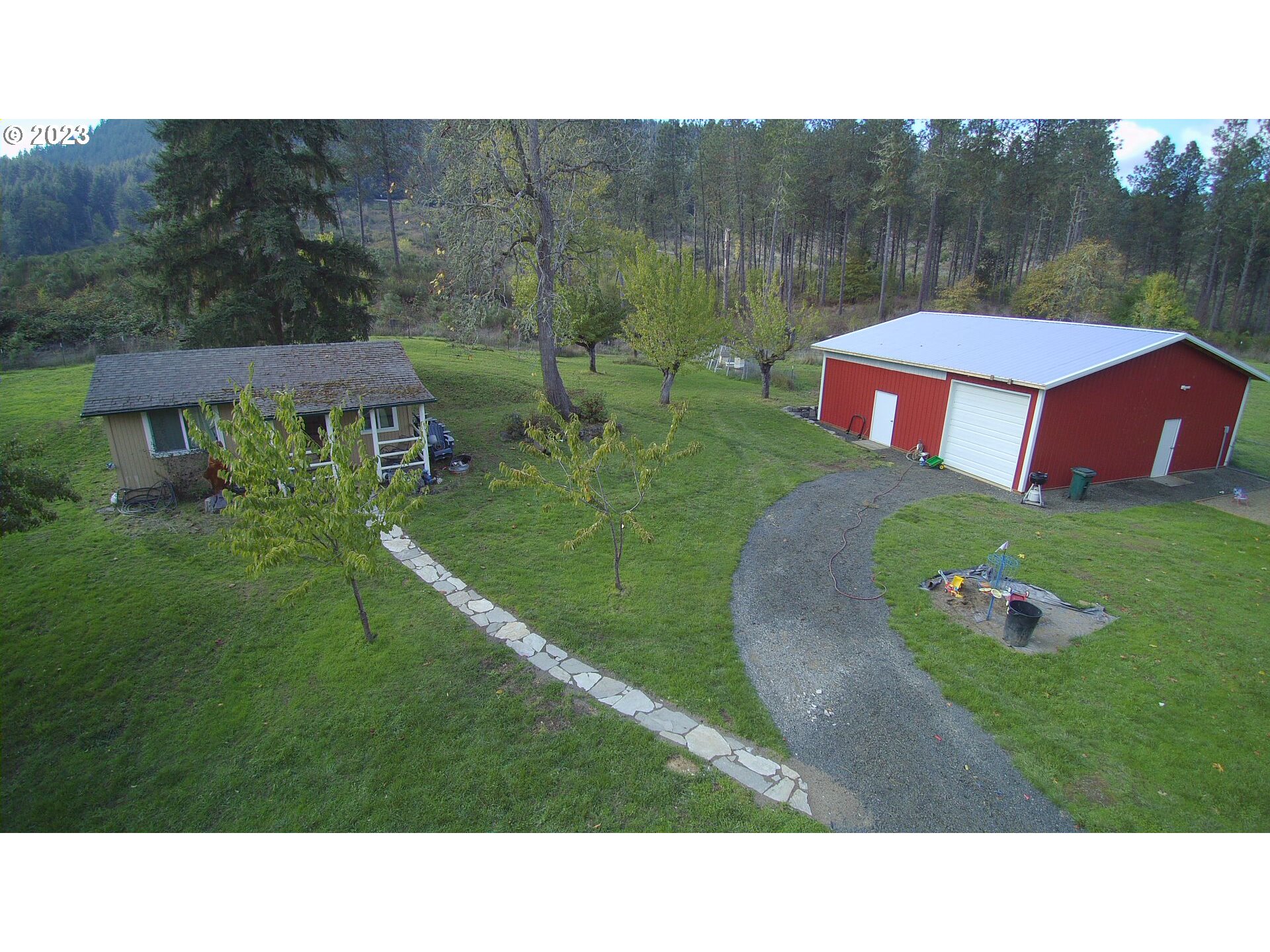 3392 Eagle Valley Road Yoncalla, OR 97499 - Photo 25 of 48 a backyard of a house with table and chairs