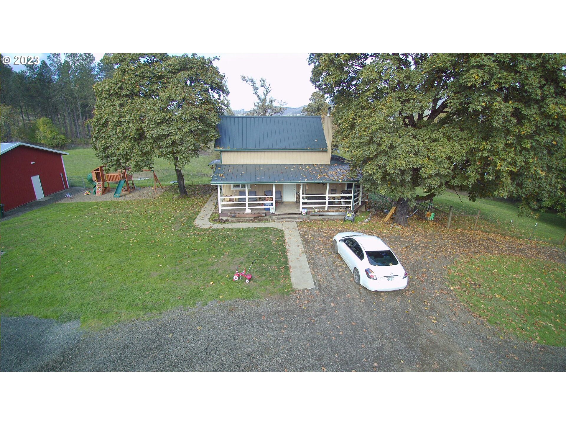 3392 Eagle Valley Road Yoncalla, OR 97499 - Photo 3 of 48 a backyard of a house with table and chairs