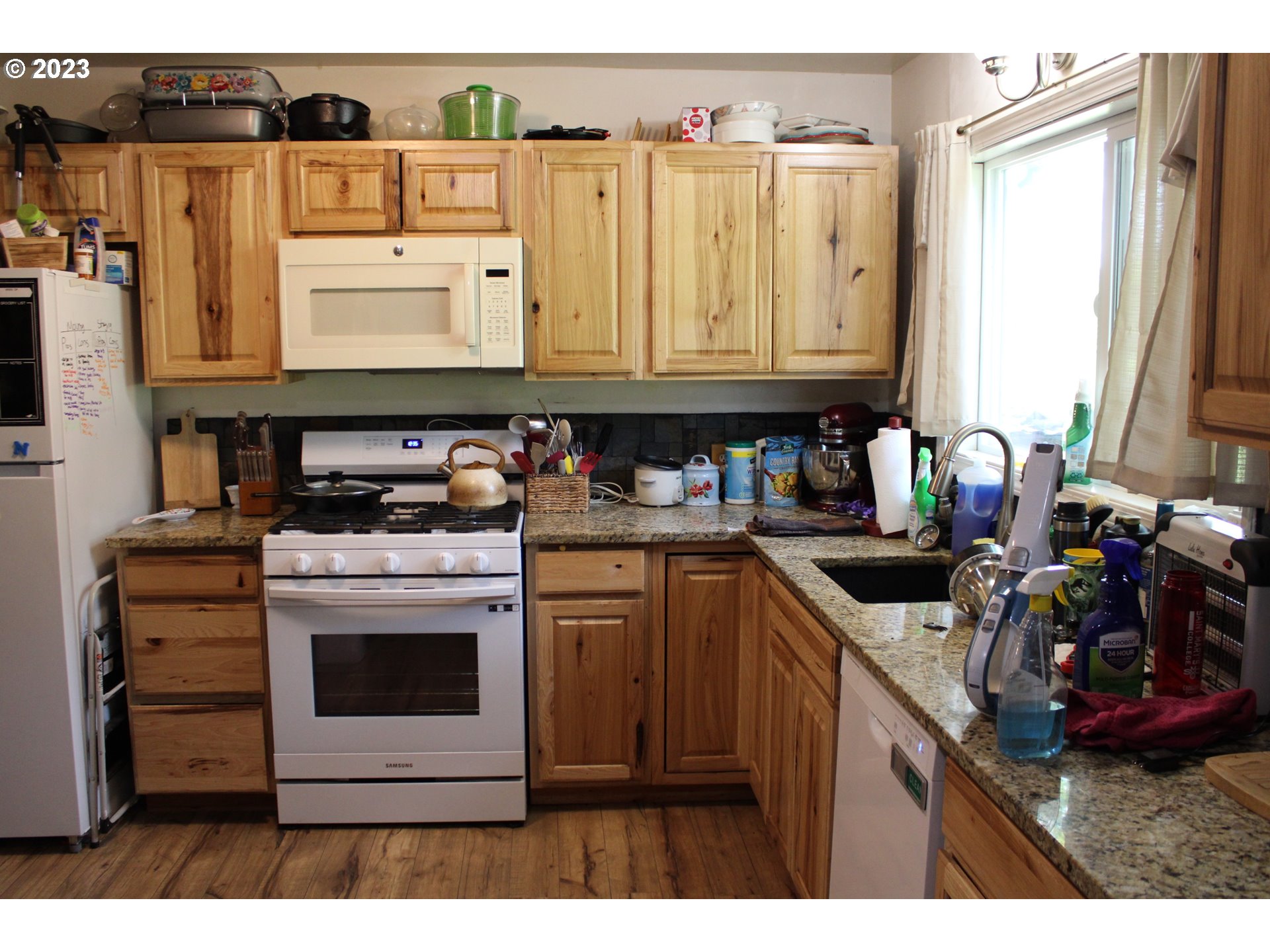 3392 Eagle Valley Road Yoncalla, OR 97499 - Photo 10 of 48 a kitchen with kitchen island granite countertop a sink stove and cabinets