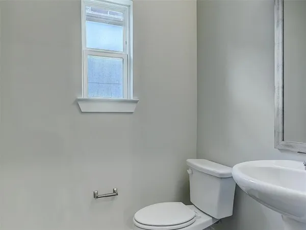 a white toilet sitting next to a white sink