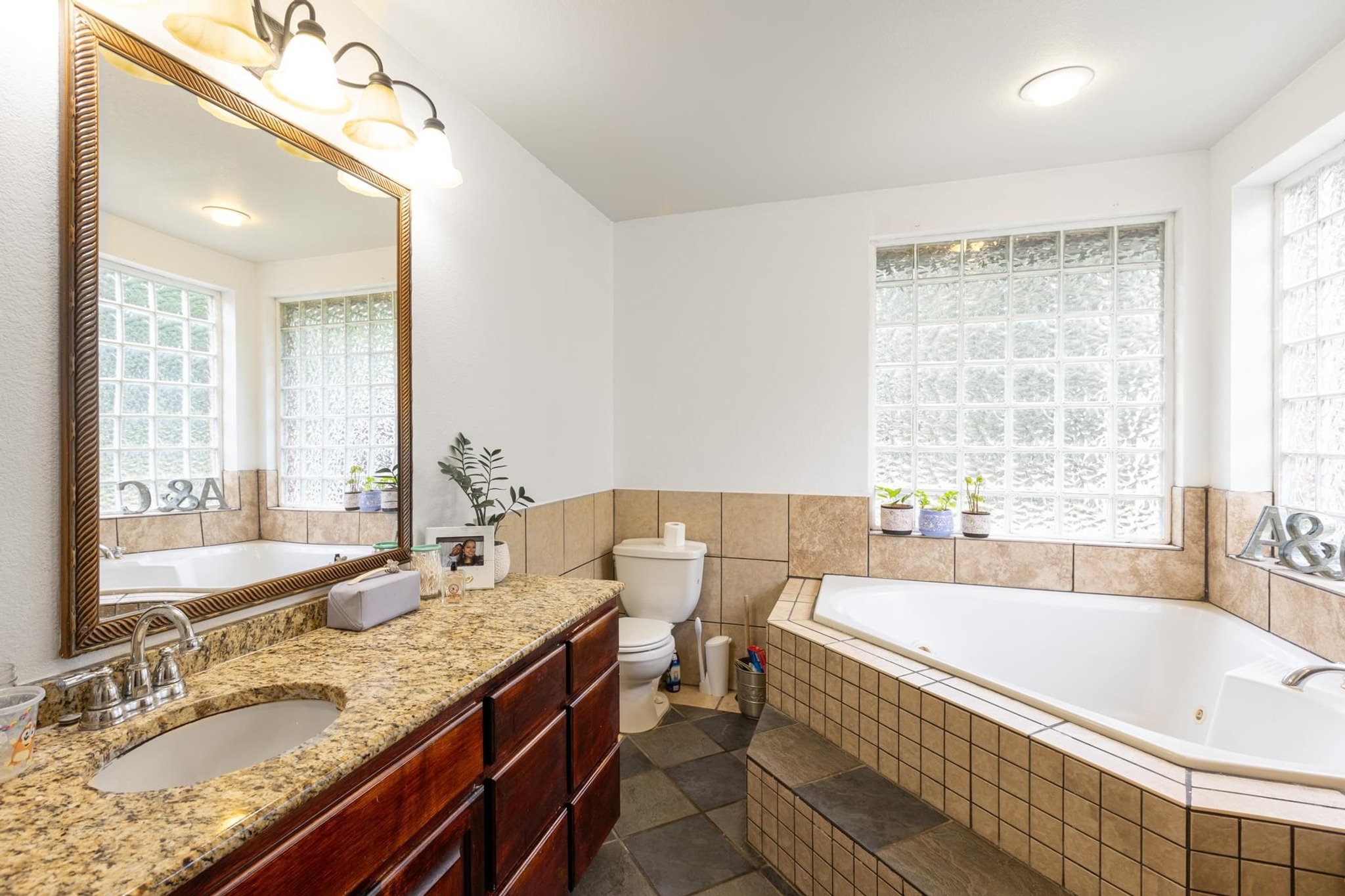 176 Old Lexington Road, Unit C Elgin, TX 78621 - Photo 18 of 31 a bathroom with a granite countertop tub sink and mirror