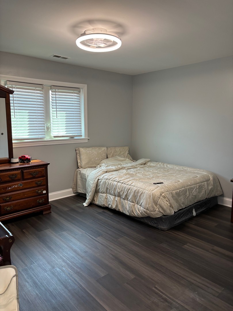 9132 South Pulaski Road, Unit 2E Oak Lawn, IL 60453 - Photo 11 of 22 a bedroom with a bed and a dresser next to a window