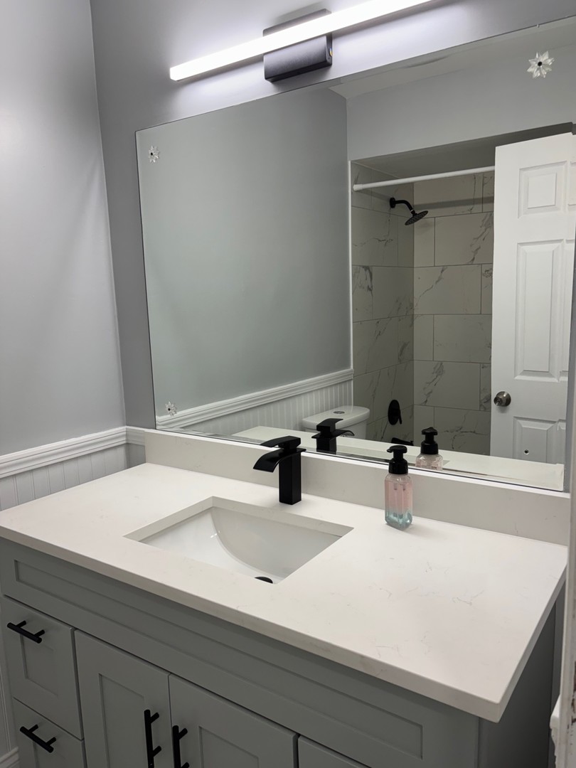 9132 South Pulaski Road, Unit 2E Oak Lawn, IL 60453 - Photo 15 of 22 a bathroom with a sink and a mirror