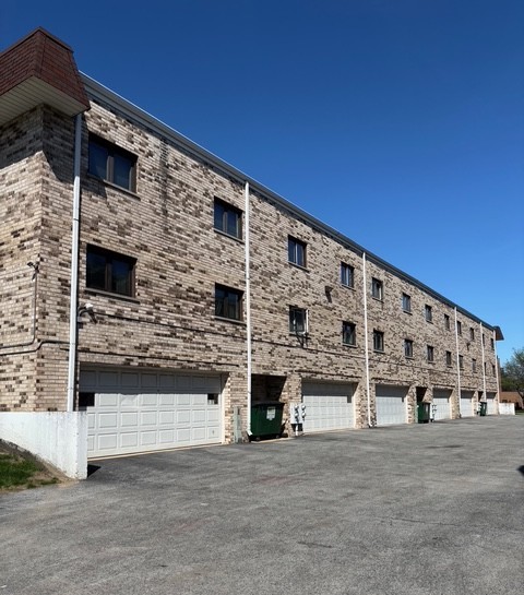 9132 South Pulaski Road, Unit 2E Oak Lawn, IL 60453 - Photo 2 of 22 a large building with a large windows