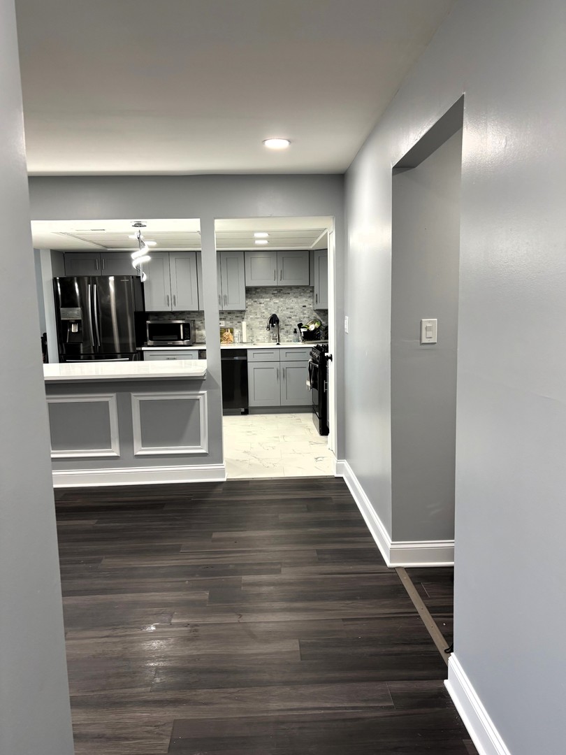 9132 South Pulaski Road, Unit 2E Oak Lawn, IL 60453 - Photo 4 of 22 a view of a kitchen with fridge and wooden floor