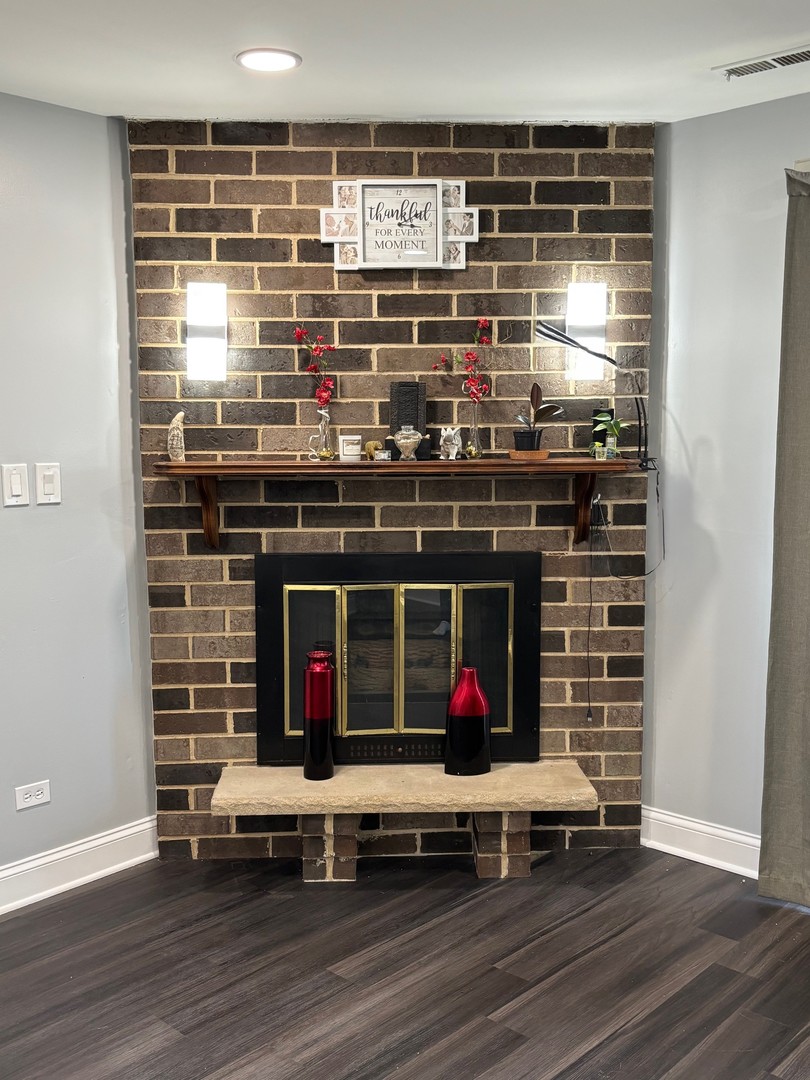 9132 South Pulaski Road, Unit 2E Oak Lawn, IL 60453 - Photo 8 of 22 a room with wooden floor and potted plant