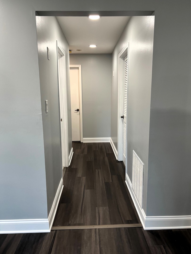 9132 South Pulaski Road, Unit 2E Oak Lawn, IL 60453 - Photo 9 of 22 a view of a hallway with wooden floor