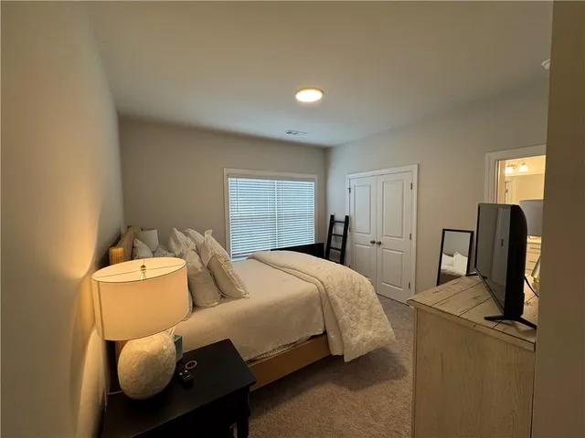 a bedroom with bed and window