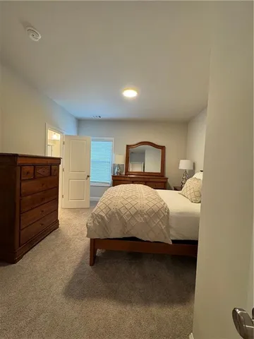 a bedroom with a large bed and a dresser