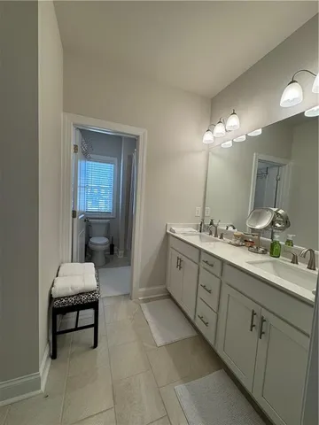 a bathroom with a double vanity sink and a mirror