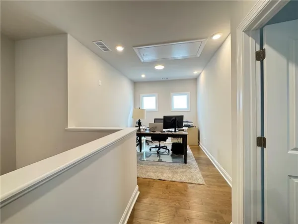 a spacious bathroom with a mirror a shower and a sink