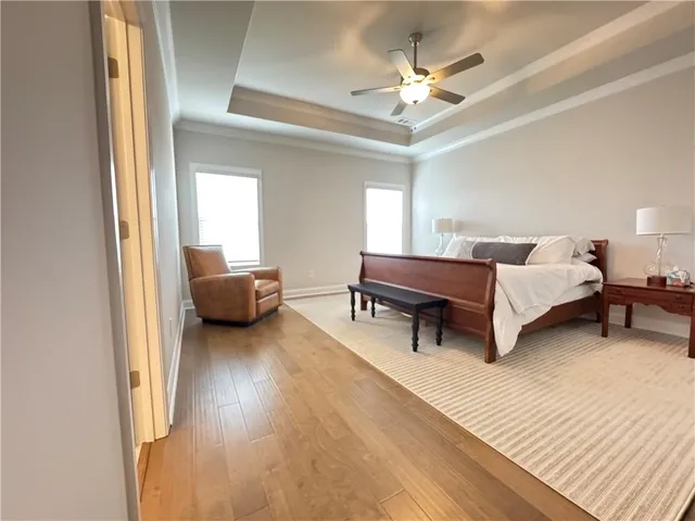 a living room with furniture and a ceiling fan