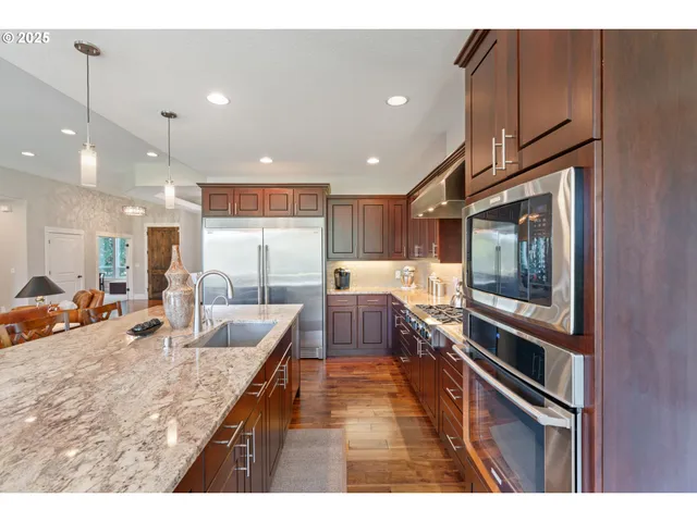 a kitchen with granite countertop a stove and a sink