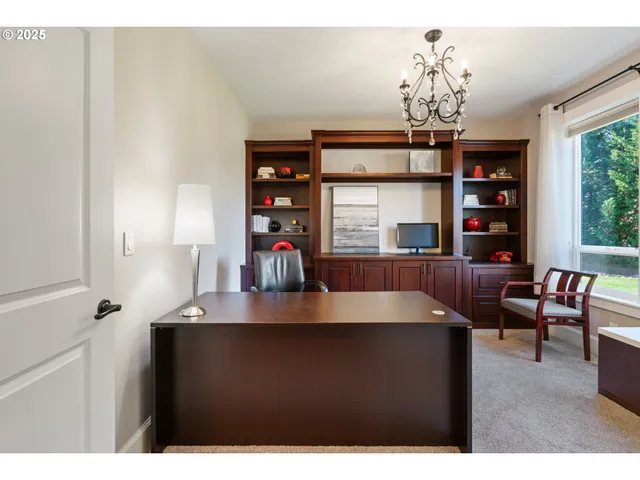 a view of a dining room with furniture and chandelier