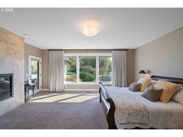 a bedroom with a bed and a large window