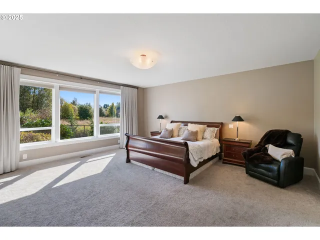 a spacious bedroom with a bed and large window