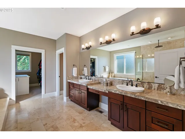 a large bathroom with double vanity and a large mirror