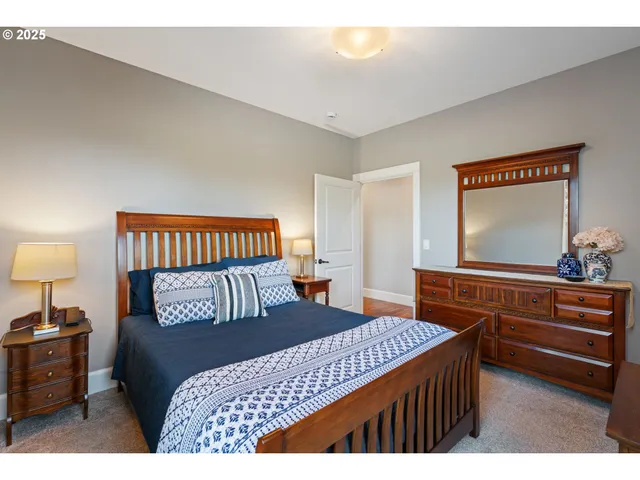 a bedroom with a bed and a dresser in it